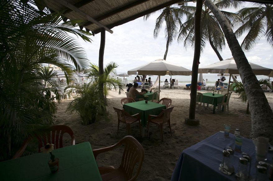 Tables sit empty at a seaside restaurant along Pampatar beach on Margarita Island, Venezuela, Wednesday, Sept. 14, 2016. Top officials flying in from around the world this week for the summit of the Cold War-era Non-Aligned Movement will see infrastructure from Margarita Island's glory days, including large waterfront hotels and three sprawling shopping centers featuring high-end stores, though they are now mostly empty. (AP Photo/Ariana Cubillos)