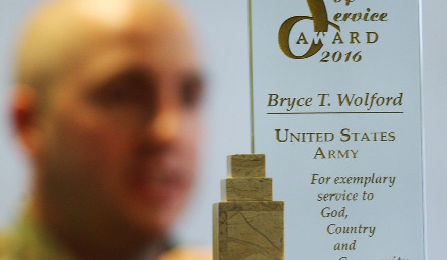 In this Wednesday, Sept. 7, 2016 photo, Cpl. Bryce Wolford, an intelligence analyst with Fort Wainwright's 3rd Battalion, 21st Infantry Regiment, speaks during an interview in Fairbanks, Alaska. Wolford recently received the American Legion 2016 Spirit of Service Award. (Eric Engman/Fairbanks Daily News-Miner via AP)