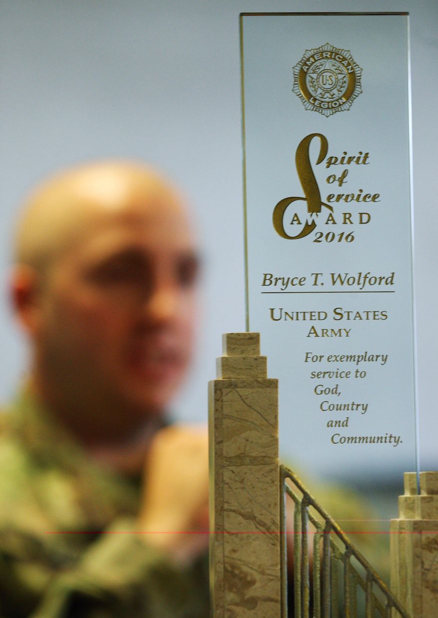 In this Wednesday, Sept. 7, 2016 photo, Cpl. Bryce Wolford, an intelligence analyst with Fort Wainwright's 3rd Battalion, 21st Infantry Regiment, speaks during an interview in Fairbanks, Alaska. Wolford recently received the American Legion 2016 Spirit of Service Award. (Eric Engman/Fairbanks Daily News-Miner via AP)