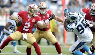 San Francisco 49ers&#39; Blaine Gabbert (2) tries to avoid the rush of Carolina Panthers&#39; Charles Johnson (95) in the first half of an NFL football game in Charlotte, N.C., Sunday, Sept. 18, 2016. (AP Photo/Mike McCarn)