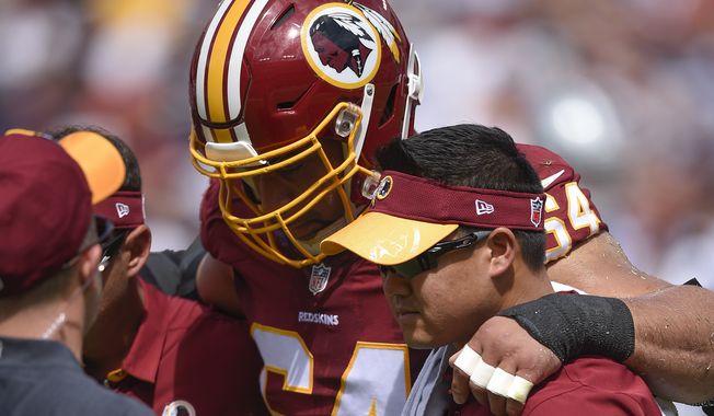 Washington Redskins defensive end Kedric Golston (64) is helped off the field after an injury during the first half of an NFL football game against the Dallas Cowboys in Landover, Md., Sunday, Sept. 18, 2016. (AP Photo/Nick Wass)