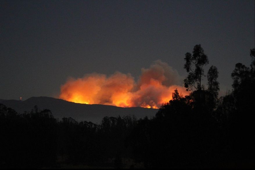 This photo released by the U.S. Air Force shows a wildfire burning at a central California Air Force base on Sunday, Sept. 18, 2016, that forced the postponement of a satellite launch at Vandenberg Air Force Base, Calif. An Atlas 5 rocket was to carry a satellite known as WorldView-4 into orbit from Vandenberg Air Force Base. The satellite is designed to produce high-resolution images of Earth from space. The fire burning in a remote canyon didn't immediately threaten the space launch complex, Col. Paul Nosek said on the base's Facebook page. Nearly 800 firefighters were trying to corral the fire that was slightly less than a square mile in size. No new date was set for the launch, Lt. William Collette said. (Col. Michael Wulfestieg/U.S. Air Force via AP)