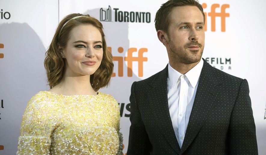 FILE - In a Sept. 12, 2016 file photo, Ryan Gosling, right, and Emma Stone arrive on the red carpet for the film "La La Land" during the 2016 Toronto International Film Festival in Toronto. The top award at the Toronto International Film Festival was awarded Sunday, Sept. 18, to Damien Chazelle’s "La La Land”, a modern-day musical starring Emma Stone and Ryan Gosling. (Chris Young/The Canadian Press via AP, File)