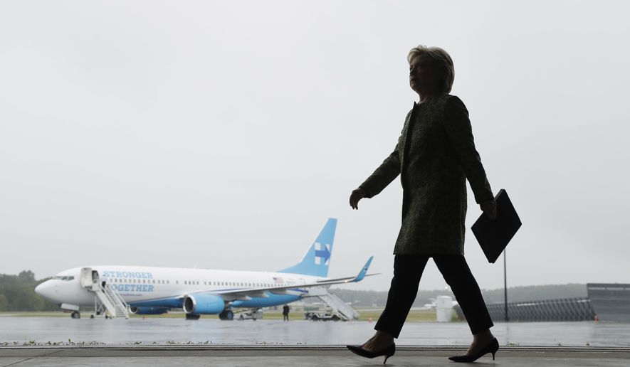 Democratic presidential candidate Hillary Clinton walks to a podium to speak with members of the media at Westchester County Airport in White Plains, N.Y., Monday, Sept. 19, 2016. (AP Photo/Matt Rourke)