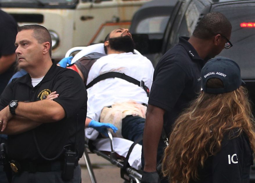 Ahmad Khan Rahami is taken into custody after a shootout with police Monday, Sept. 19, 2016, in Linden, N.J. Rahami was wanted for questioning in the bombings that rocked the Chelsea neighborhood of New York and the New Jersey shore town of Seaside Park. (Ed Murray/NJ Advance Media via AP)