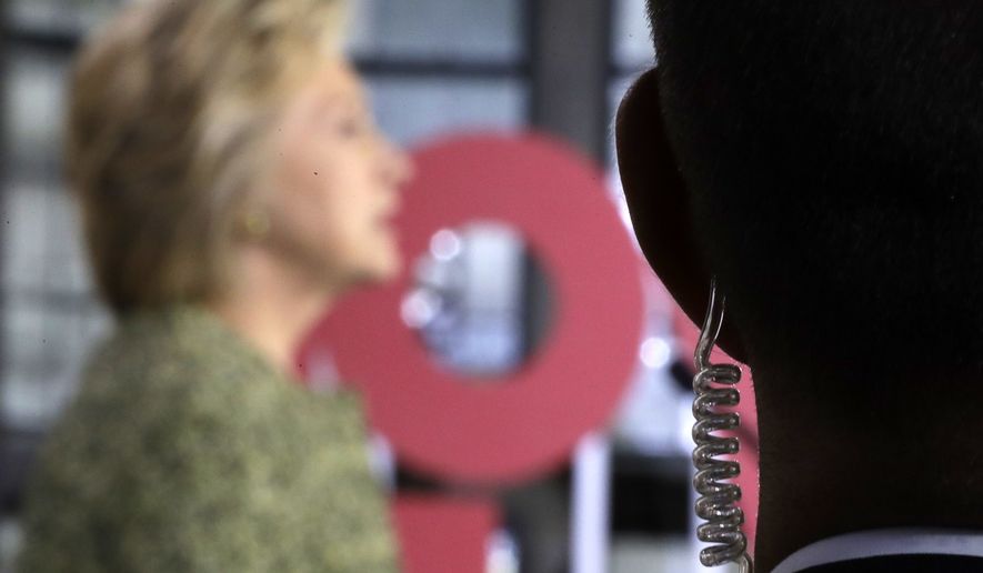 A Secret Service agent stands guard as Democratic presidential candidate Hillary Clinton speaks during a campaign stop at Temple University in Philadelphia, Monday, Sept. 19, 2016. (AP Photo/Matt Rourke)