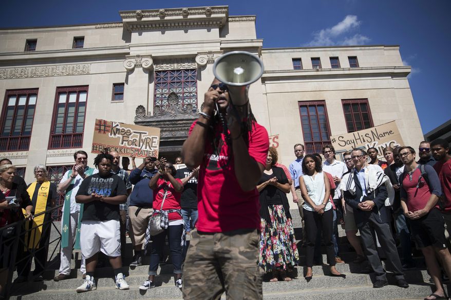 Demonstrator Aramis Malachi-Ture Sundiata, center, speaks during a rally for Tyre King on Monday, Sept. 19, 2016, outside City Hall in Columbus, Ohio. Police said King was fatally shot Wednesday by Columbus police after he ran from an officer investigating a reported armed robbery and pulled out a BB gun that looked like a real firearm. (AP Photo/John Minchillo)