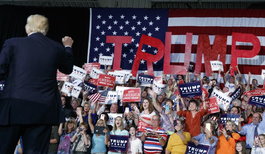 Supporters cheer as Republican presidential candidate Donald Trump arrives to speak to a campaign rally, Tuesday, Sept. 20, 2016, in Kenansville, N.C. (AP Photo/ Evan Vucci)