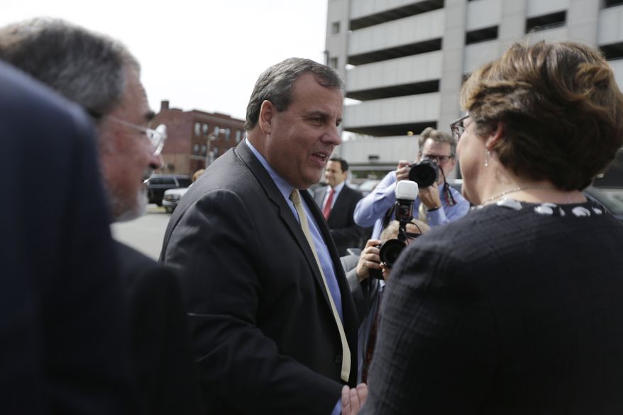 New Jersey Gov. Chris Christie, center, is greeted as he arrives at University Hospital for the grand opening of the Rutgers Cancer Institute of New Jersey, Tuesday, Sept. 20, 2016, in Newark, N.J. Christie announced the release of $33 million in state spending he had held up until lawmakers identified $250 million in retiree health costs. (AP Photo/Julio Cortez)