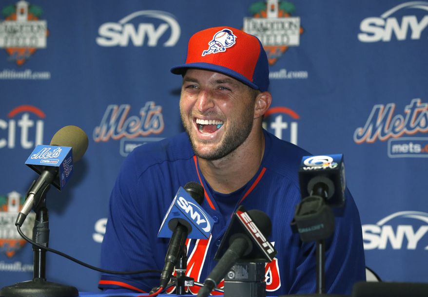 Tim Tebow laughs during a news conference, Tuesday, Sept. 20, 2016, in Port St. Lucie, Fla. The 2007 Heisman Trophy winner and former NFL quarterback practiced at the New York Mets' complex during his second workout as part of their instructional league team. (AP Photo/Wilfredo Lee)