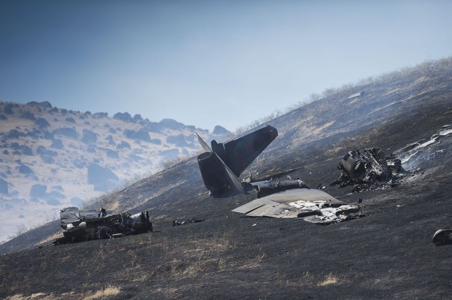 The wreckage of a U-2 spy plane that crashed after taking off from Beale Air Force Base on a training mission in Northern California, is seen Tuesday, Sept. 20, 2016. Authorities say two pilots ejected before the crash Tuesday morning in the Sierra Buttes about 60 miles north of Sacramento. The plane was destroyed and a resulting fire scorched several acres. (Hector Amezcua/The Sacramento Bee via AP)