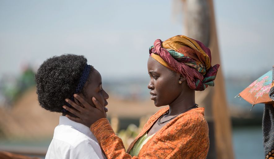 In this image released by Disney, Lupita Nyong'o, right, and Madina Nalwanga appear in a scene from "Queen of Katwe." (Edward Echwalu/Disney via AP)