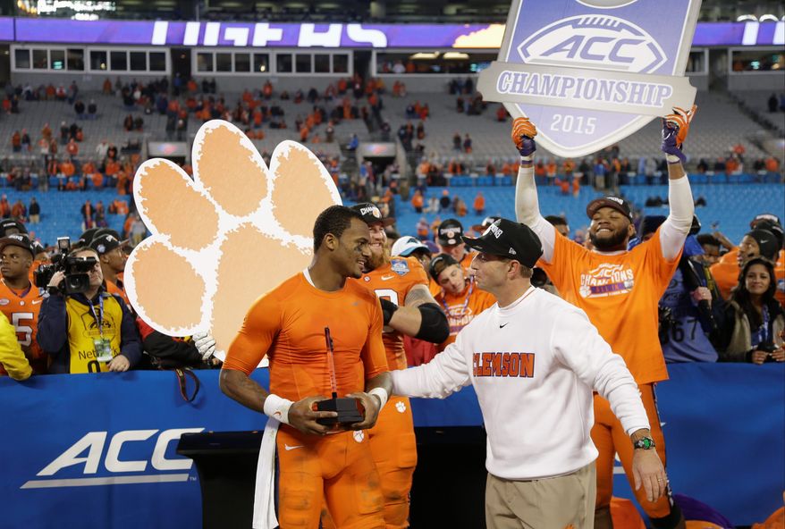 Quarterback Deshaun Watson (left), coach Dabo Swinney and the defending ACC champion Clemson Tigers may have an inside track in the Atlantic Division race, but the biggest question looming over the league is the site of this year's title game. (Associated Press)