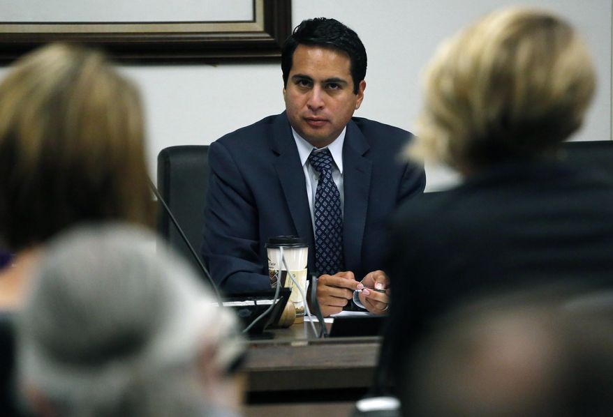 State Rep. Dan Pabon, D-Denver, hears testimony during a hearing of the Colorado state House Marijuana Cost-Benefit Analysis Interim Committee, at the state Capitol, in Denver, Wednesday, Sept. 21, 2016. A panel of state lawmakers voted 5-0 Wednesday, Sept. 21, 2016 to endorse the addition of PTSD to Colorado's 2000 medical pot law. The vote doesn't have legal effect; it's just a recommendation to the full Legislature, which resumes work in January. (AP Photo/Brennan Linsley)
