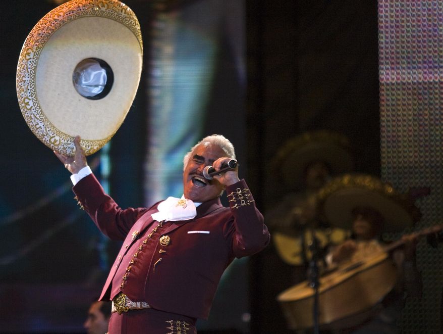 FILE - In this Feb. 14, 2009, file photo, singer Vicente Fernandez performs at a free concert during Valentine's Day in Mexico City's Zocalo. Fernandez has recorded a “corrido,” or ballad, backing Democratic presidential candidate Hillary Clinton. In a video posted on his official Facebook page Wednesday, Sept. 21, 2016, the singer known as the “King of Ranchera” music calls on people to work “hand-in-hand until Hillary Clinton has victory assured.”(AP Photo/Claudio Cruz, File)