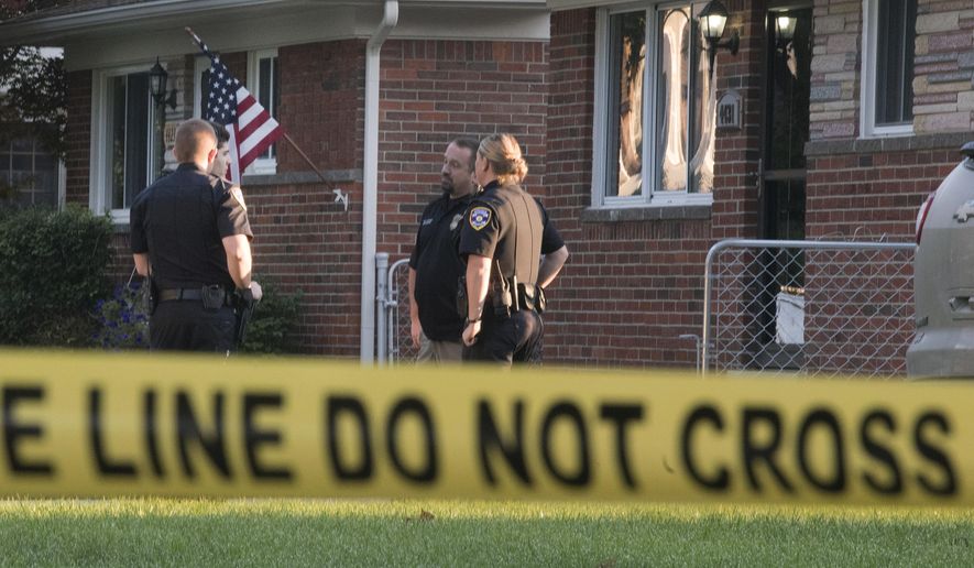 Dearborn Heights police stand outside a house at 431 Hipp street, in Dearborn Heights, Mich., on Wednesday, Sept. 21, 2016. A man is in custody after his two children were asphyxiated, his wife’s two older children were fatally shot and his wife was shot and slashed at their suburban Detroit home, police said Wednesday. (Daniel Mears/The Detroit News via AP )
