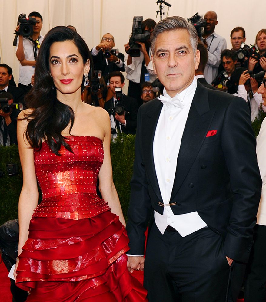 Amal Clooney, left, and George Clooney arrive at The Metropolitan Museum of Art's Costume Institute benefit gala celebrating "China: Through the Looking Glass" on Monday, May 4, 2015, in New York. (Photo by Charles Sykes/Invision/AP)