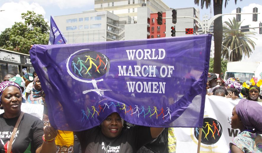 Women from Kenya, Uganda, Tanzania, Rwanda and Burundi participate in the world march of woman in Nairobi, Kenya Tuesday, Oct. 13, 2015. The women marched to protest against early marriage, sexual harassment, Female Genital Mutilation and all forms of violence and inequality against women. (AP Photo/Khalil Senosi)