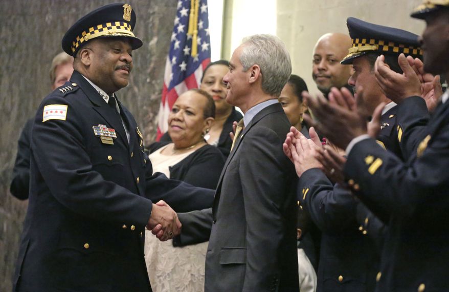 In this April 13, 2016, file photo, Chicago Mayor Rahm Emanuel shakes hands with Eddie Johnson after swearing him in as the new Chicago police superintendent in Chicago. (AP Photo/M. Spencer Green)