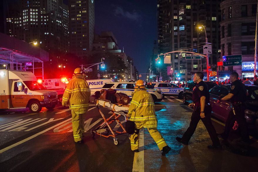 First responders work near the scene of an explosion in Manhattan&#39;s Chelsea neighborhood on Sept. 17 in New York. Although the pressure cooker bomb that wounded over two dozen people on the street went off in front of an apartment building for the blind, none of the building&#39;s residents were hurt in the blast. (Associated Press)