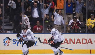 Team North America&#39;s Nathan MacKinnon, left, celebrates his game winning goal with teammate Shayne Gostisbehere against Sweden during overtime of a World Cup of Hockey game in Toronto on Wednesday, Sept. 21, 2016. (Mark Blinch/The Canadian Press via AP)
