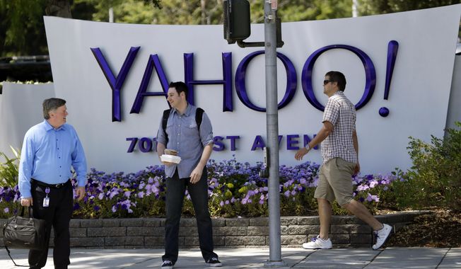 FILE - In this June 5, 2014, file photo, people walk in front of a Yahoo sign at the company&#x27;s headquarters in Sunnyvale, Calif. Yahoo says the personal information of 500 million accounts have been stolen in a massive security breakdown that represents the latest setback for the beleaguered internet company. The breach disclosed on Thursday, Sept. 22, 2016, dates back to late 2014. Yahoo is blaming the hack on a “state-sponsored actor.” (AP Photo/Marcio Jose Sanchez, File)