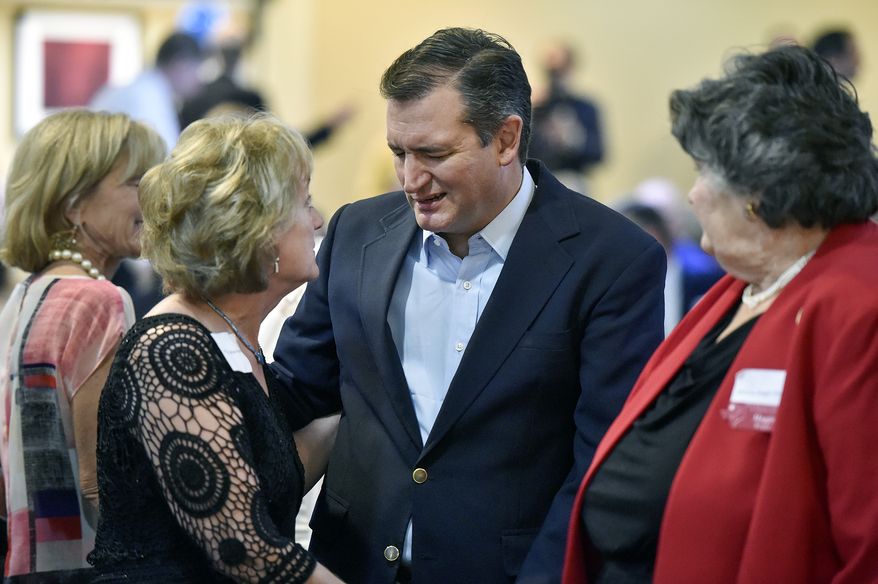 Sen. Ted Cruz, Texas Republican, talks with Cathie Adams, past president of Texas Eagle Forum, at the annual Grassroots America We The People Champions of Freedom award dinner Friday. Mr. Cruz announced he will vote for Donald Trump. (Associated Press)