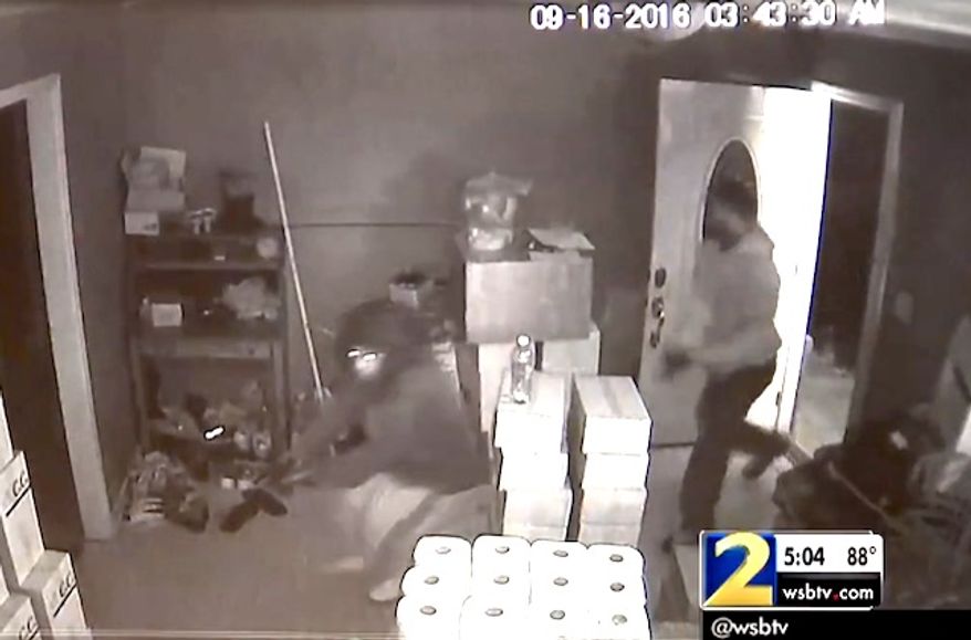 A man bursts through the door of a restaurant manager in Gwinnett County, Georgia, on Friday, Sept. 23, 2016. The home owner repelled him and two others with a personal firearm. One suspect was killed. (WSB-TV 2 ABC Atlanta screenshot)
