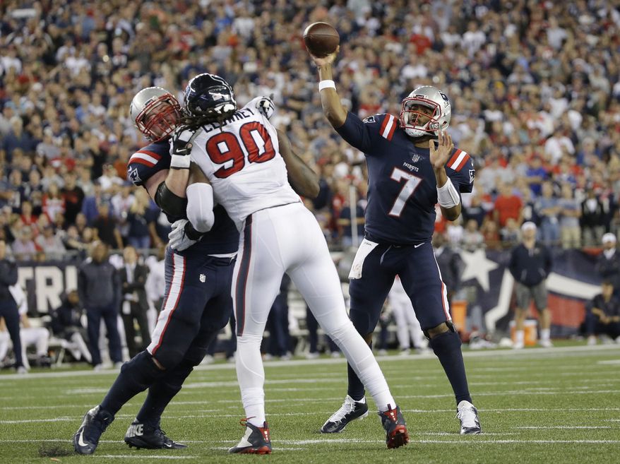 In this Thursday, Sept. 22, 2016 photo, New England Patriots quarterback Jacoby Brissett (7) passes over Houston Texans defensive end Jadeveon Clowney (90) during the second half of an NFL football game Thursday, Sept. 22, 2016, in Foxborough, Mass. The patriots could be looking for yet another quarterback — or two — after third-stringer Jacoby Brissett injured his right thumb in Thursday night's victory over Houston. (AP Photo/Elise Amendola)