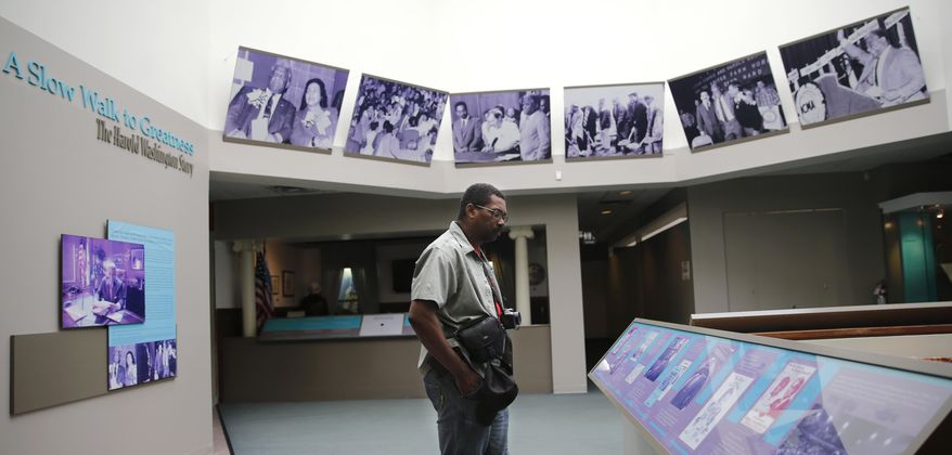 Charles Boyles looks at the exhibition at the DuSable Museum of African American History Thursday, Sept. 22, 2016, in Chicago. The dedication of the Smithsonian Institution's National Museum of African American History and Culture will be celebrated on Saturday in Washington and on Chicago's south side at one of the oldest museums of its kind. (AP Photo/Tae-Gyun Kim)
