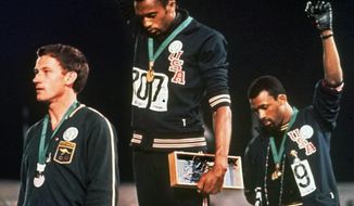 FILe - In this Oct. 16, 1968, file photo, U.S. athletes Tommie Smith, center, and John Carlos stare downward while extending gloved hands skyward during the playing of the Star Spangled Banner after Smith received the gold and Carlos the bronze for the 200 meter run at the Summer Olympic Games in Mexico City. Australian silver medalist Peter Norman is at left. Smith and Carlos, the American sprinters whose raised-fist salutes at the 1968 Olympics are an ageless sign of race-inspired protest, will join the U.S. Olympic team at the White House next week for its meeting with President Barack Obama. Smith and Carlos were sent home from the Olympics after raising their black-gloved fists in a symbolic protest during the U.S. national anthem. They called it a ``human rights salute.&#39;&#39;The USOC asked them to serve as ambassadors as it tries to make its own leadership more diverse. (AP Photo/File)