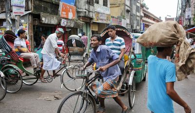 A Bangladeshi rickshaw transports a passenger in Old Dhaka, Bangladesh, Saturday, Sept. 24, 2016. Rickshaws are the most popular means of public transport in Dhaka. (AP Photo/A.M.Ahad)
