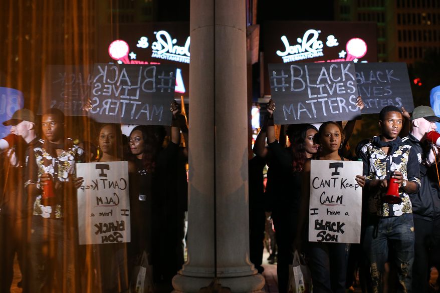 Black Lives Matter protesters march in downtown Atlanta, Saturday, Sept. 24, 2016, in response to the police shooting deaths of Terence Crutcher in Tulsa, Okla., and Keith Lamont Scott in Charlotte, N.C. (AP Photo/Branden Camp)