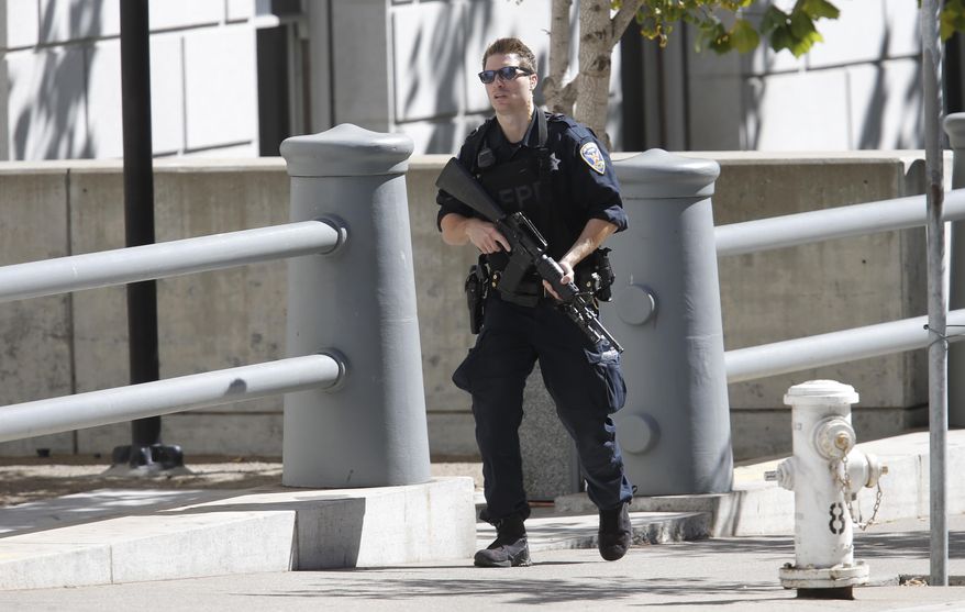 A San Francisco Police officer responds to the scene of a standoff of a possibly armed man in Civic Center Plaza in San Francisco, Saturday, Sept. 24, 2016. (Michael Macor/San Francisco Chronicle via AP)