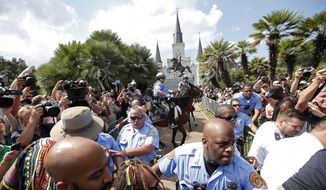 New Orleans police guard a statue of Andrew Jackson, in Jackson Square, during a protest organized by Take &#39;Em Down NOLA, who threatened to tear the statue down, in New Orleans, Saturday, Sept. 24, 2016. (AP Photo/Gerald Herbert) ** FILE **