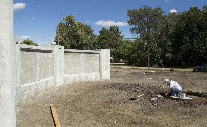 ADVANCE FOR SATURDAY SEPT. 24 AND THEREAFTER - In this Sept. 16, 2016 photo, Gary Miller works on a concrete form for a flag pole in North Loup, Neb. at the site of the new Loup Valley Veterans Memorial Park. The Loup Valley Veterans Memorial Park is a project the American Legion and Auxiliary Ralph R. Rich Post and Unit 285 have been working on for nearly two years. (Zach Mayhew/The Independent via AP)