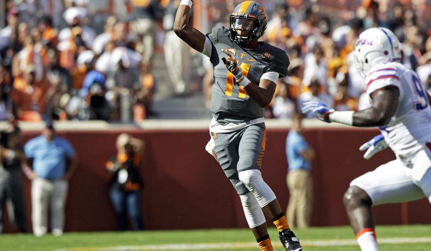 Tennessee quarterback Joshua Dobbs (11) throws to a receiver during the first half of an NCAA college football game against Florida Saturday, Sept. 24, 2016, in Knoxville, Tenn. (AP Photo/Wade Payne)