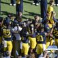 Michigan football players raise their fists up in protest during the National Anthem, before an NCAA college football game against Penn State, Saturday, Sept. 24, 2016, in Ann Arbor, Mich.  (Junfu Han/The Ann Arbor News via AP)