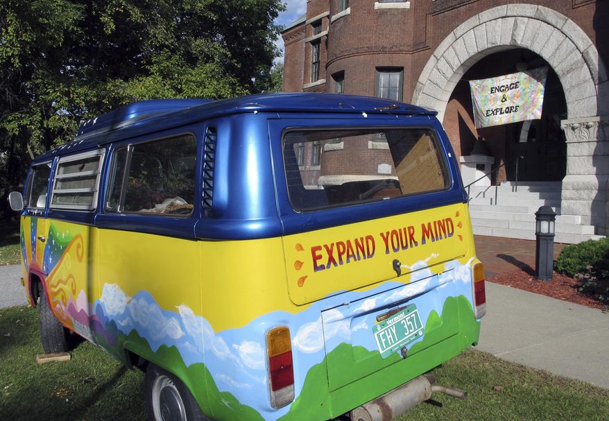 In this Thursday, Sept. 22, 2016 photo, a vintage Volkswagen van sits outside the Vermont History Center in Barre, Vt., to promote "Freaks, Radicals & Hippies," a new exhibit about the state in the 1970s that opens there on Saturday after two years of research. (AP Photo/Lisa Rathke)