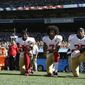 San Francisco 49ers Eli Harold (58), Colin Kaepernick (7) and Eric Reid (35) kneel during the national anthem before an NFL football game against the Seattle Seahawks, Sunday, Sept. 25, 2016, in Seattle. (AP Photo/Ted S. Warren)