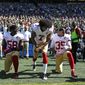 San Francisco 49ers Eli Harold (58), Colin Kaepernick (7) and Eric Reid (35) drop to a kneeling position at the beginning of the national anthem before an NFL football game against the Seattle Seahawks, Sunday, Sept. 25, 2016, in Seattle. (AP Photo/Ted S. Warren)