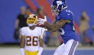 New York Giants wide receiver Odell Beckham Jr. celebrates his touchdown as Washington Redskins cornerback Bashaud Breeland (26) looks on during the second half an NFL football game Thursday, Sept. 24, 2015, in East Rutherford, N.J. (AP Photo/Bill Kostroun)