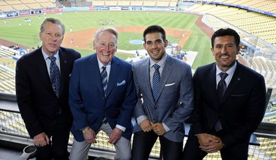 In this Tuesday, Sept. 20, 2016 photo, Dodgers broadcasters, from left, Orel Hershiser, Vin Scully, Joe Davis and Nomar Garciaparra pose prior to a baseball game between the Los Angeles Dodgers and the San Francisco Giants in Los Angeles. As Scully closes out his Hall of Fame career calling Los Angeles Dodgers games, his successor is waiting in the wings. Joe Davis has been working road games for the team this season, warming up for next year when the 28-year-old will move into Scully&#x27;s old booth full-time. (AP Photo/Mark J. Terrill)