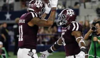 Texas A&amp;amp;M wide receiver Josh Reynolds (11) and running back Trayveon Williams (5) celebrate a touchdown run by Williams during the second half of an NCAA college football game against Arkansas on Saturday, Sept. 24, 2016, in Arlington, Texas. (AP Photo/Tony Gutierrez)
