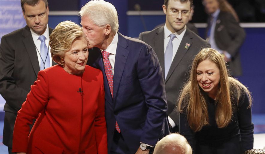 Former President Bill Clinton kisses Democratic presidential nominee Hillary Clinton as she and their daughter Chelsea Clinton greet supports during the presidential debate at Hofstra University in Hempstead, N.Y., Monday, Sept. 26, 2016. (AP Photo/David Goldman)