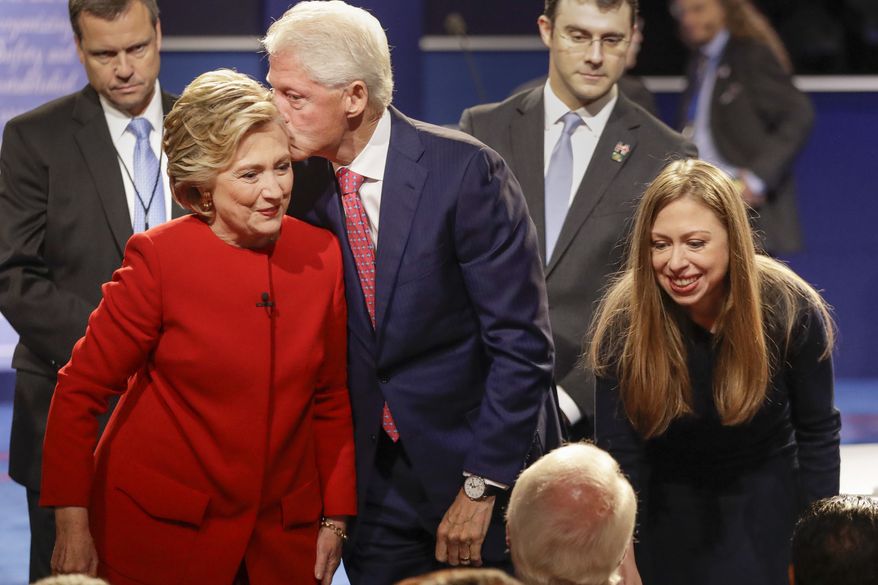 Former President Bill Clinton kisses Democratic presidential nominee Hillary Clinton as she and their daughter Chelsea Clinton greet supports during the presidential debate at Hofstra University in Hempstead, N.Y., Monday, Sept. 26, 2016. (AP Photo/David Goldman)