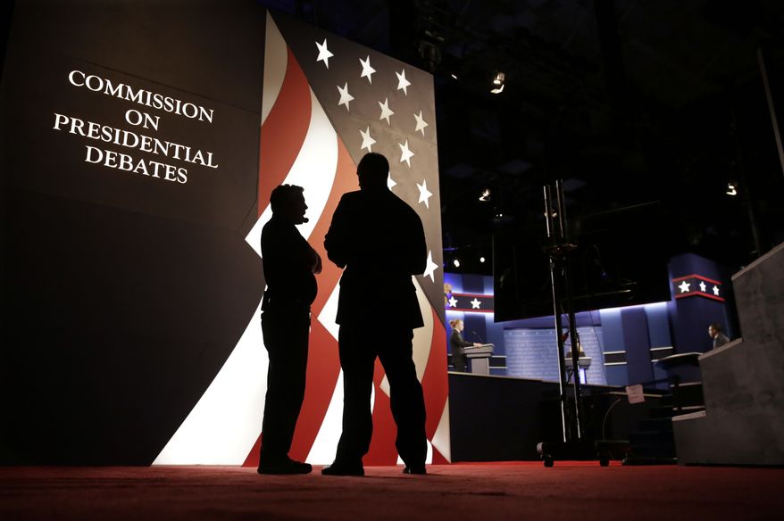 Producers stand next to the stage for the presidential debate between Democratic presidential candidate Hillary Clinton and Republican presidential candidate Donald Trump at Hofstra University in Hempstead, N.Y., Monday, Sept. 26, 2016. (AP Photo/David Goldman)