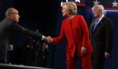 Hillary Clinton shakes hands with moderator Lester Holt as Donald Trump looks on at the first presidential debate Monday at Hofstra University in Hempstead, New York. (Associated Press)