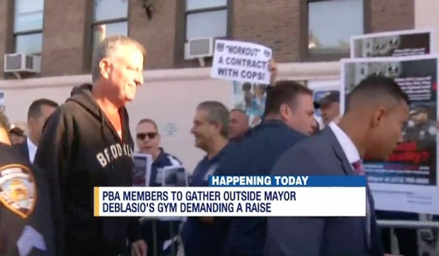 Dozens of New York City police officers hurled demands and booed at Mayor Bill de Blasio on his way into a Brooklyn gym Monday morning. (News 12)