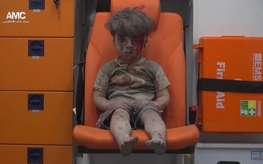 Five-year-0ld Omran Daqneesh sits in an ambulance after being pulled out of a building hit by an airstrike in Aleppo, Syria. White Helmets chief Raed al-Saleh said the city's 275,000 civilians are "sitting in their homes, waiting to die" amid airstrikes. (Associated Press)
